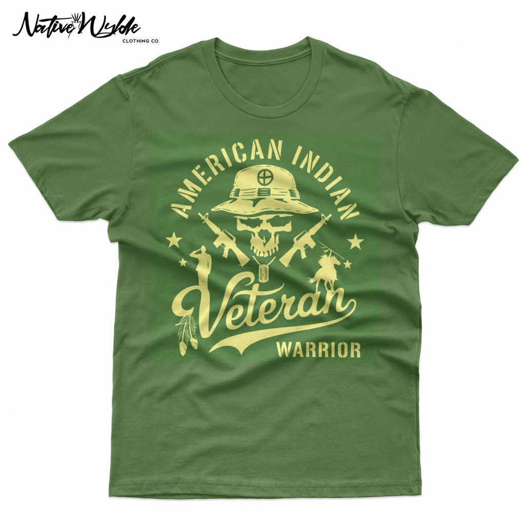 An army green short-sleeve T-shirt with a large graphic print on the front. The graphic features a skull wearing a military boonie hat, crossed rifles, and the words 'AMERICAN INDIAN Veteran WARRIOR' in a bone color.