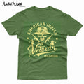 An army green short-sleeve T-shirt with a large graphic print on the front. The graphic features a skull wearing a military boonie hat, crossed rifles, and the words 'AMERICAN INDIAN Veteran WARRIOR' in a bone color.