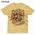 A light beige graphic t-shirt featuring a traditional tattoo-style design with a skull in a top hat, flames, a bird, and banners reading 'Oklahoma Original' and 'Wild & Free'.