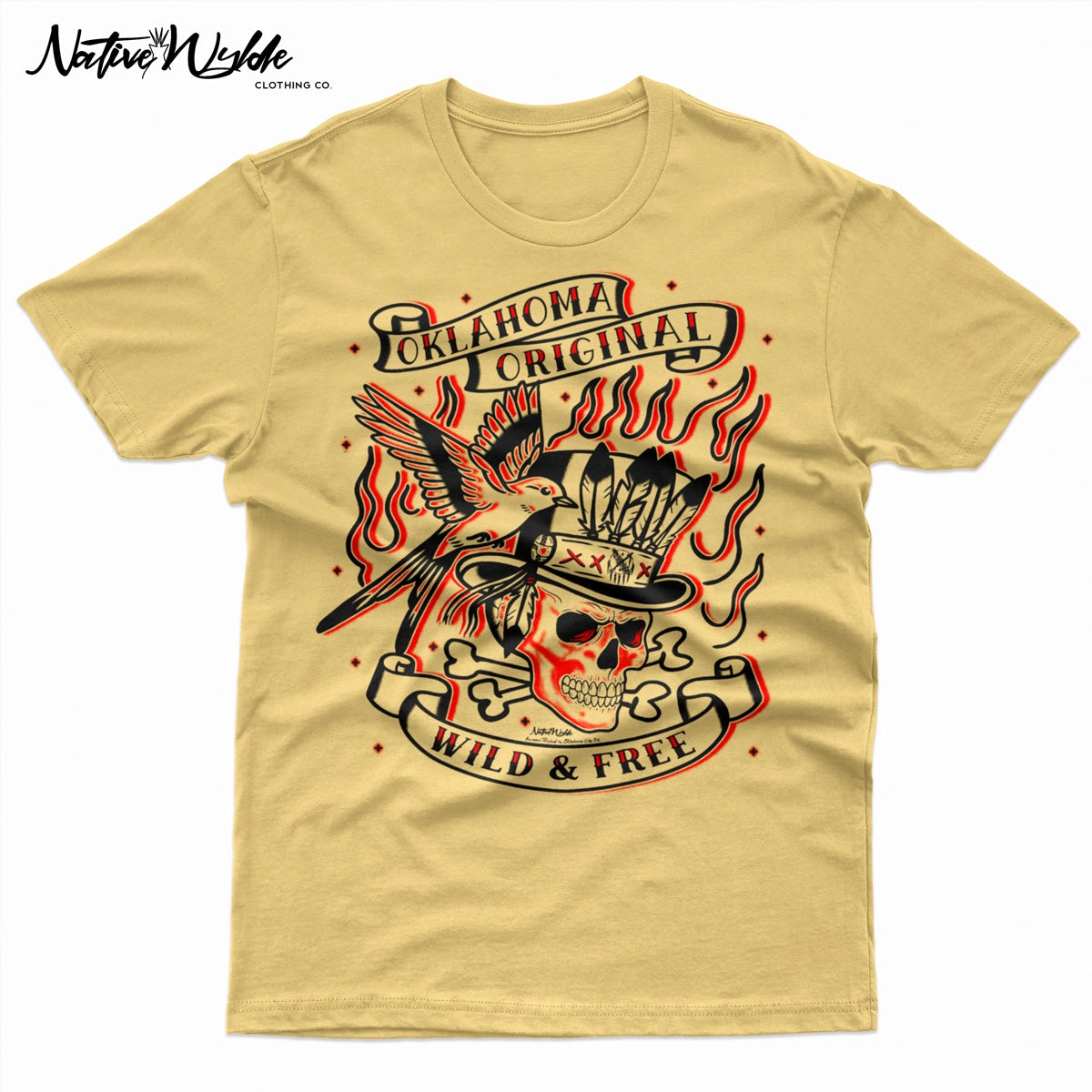 A light beige graphic t-shirt featuring a traditional tattoo-style design with a skull in a top hat, flames, a bird, and banners reading 'Oklahoma Original' and 'Wild & Free'.