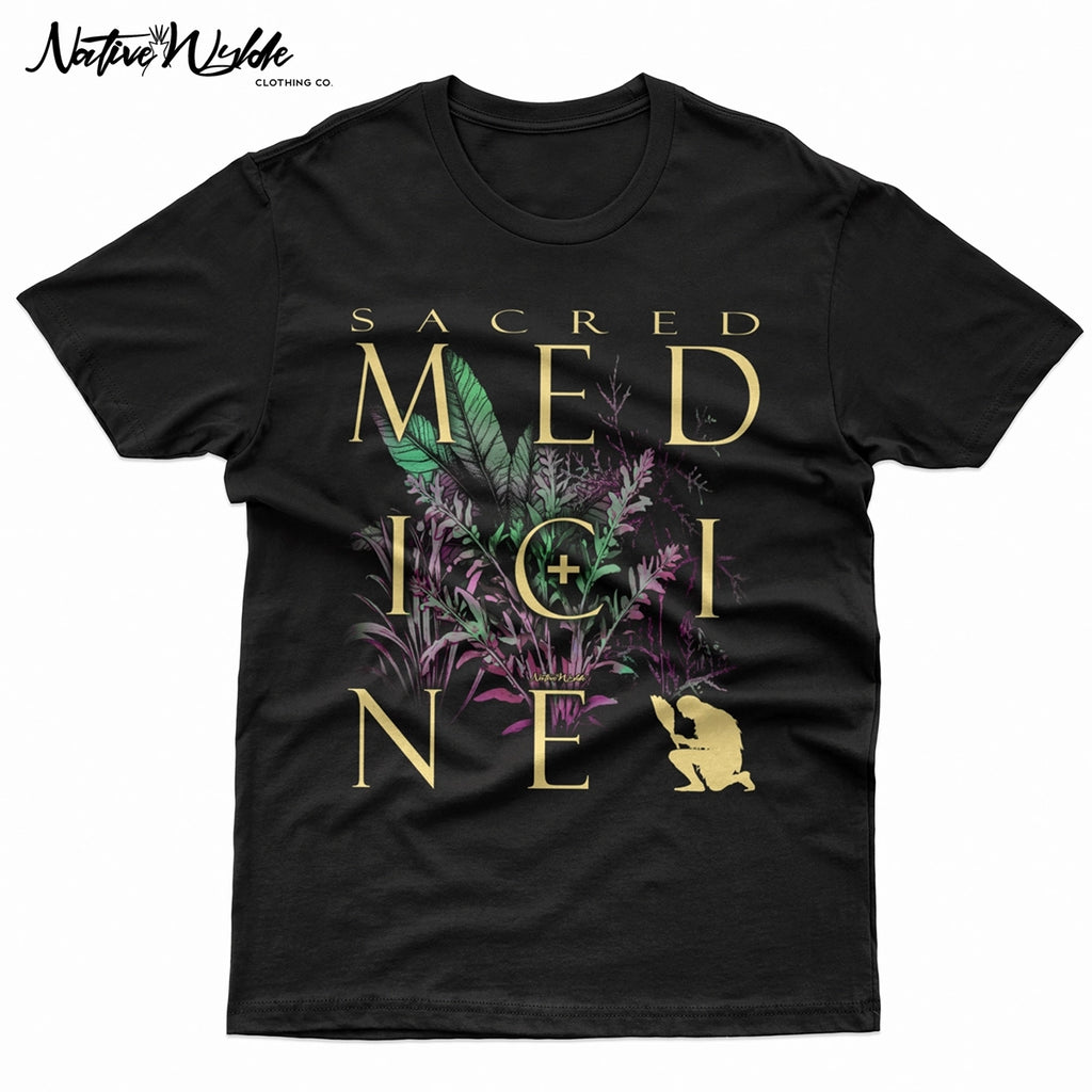 A black T-shirtfeaturing a large graphic print with the words 'SACRED MEDICINE' in bone lettering, layered over botanical illustrations in green and purple.