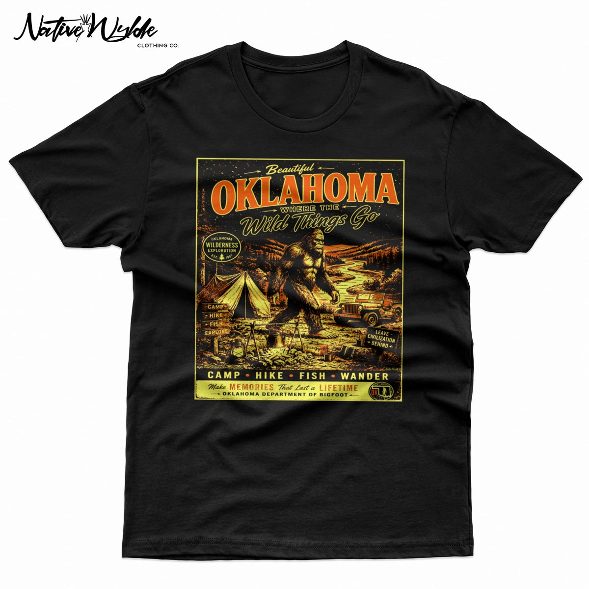 A vintage-style Oklahoma travel poster graphic printed on a black shirt. The design features large orange-red 'OKLAHOMA' lettering, a Bigfoot scene with a tent, jeep, river, and campfire, plus yellow text reading 'Where the Wild Things Go' and 'Make Memories That Last a Lifetime'.