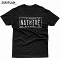 A black short-sleeve t-shirt with a distressed white graphic of a vintage Native American license plate reading 'Oklahoma Native and 'Wild and Free' November  1907