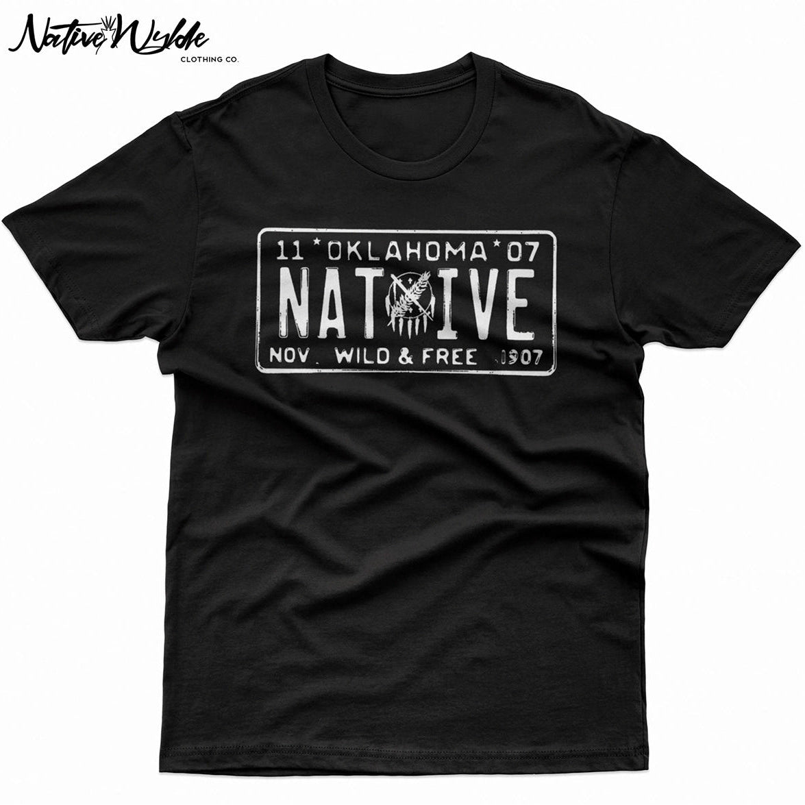 A black short-sleeve t-shirt with a distressed white graphic of a vintage Native American license plate reading 'Oklahoma Native and 'Wild and Free' November  1907