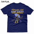 A navy blue graphic print featuring a stylized Route 66 theme with the text 'Route 66 Oklahoma's Salty Stretch', 'STAY SALTY', and 'KEEP CRUISING'. The design includes a woman holding a yellow umbrella, a map with labeled cities, and distressed yellow and white lettering.