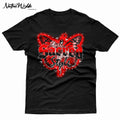 A black graphic t-shirt featuring a red and black butterfly design with the text 'Sacred Style' and 'I AM MY MOTHERS SAVAGE DAUGHTER'. Fancy shawl Native American dancer in the middle of the wings.