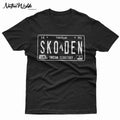 A black short-sleeve t-shirt with a distressed white graphic of a vintage Native American license plate reading 'SKODEN' and 'INDIAN TERRITORY', shown flat on a white background.