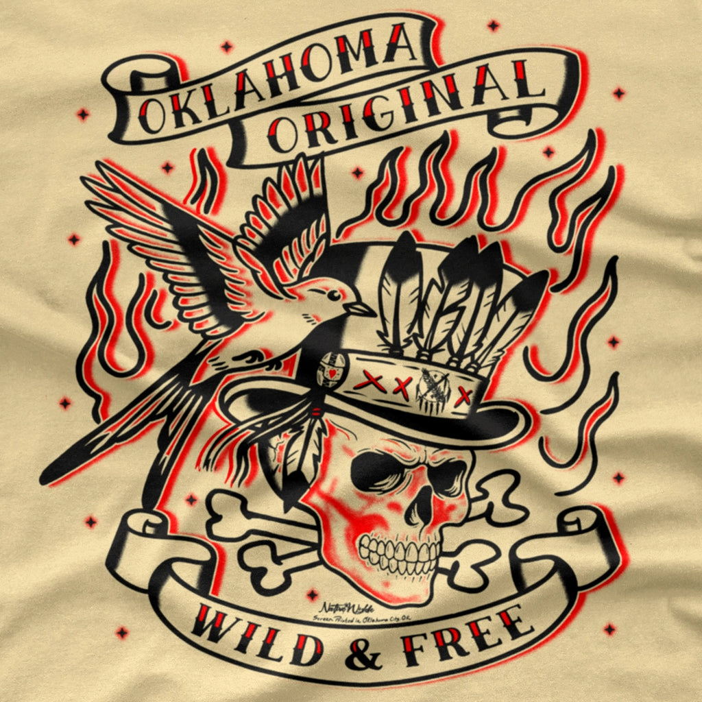 A close-up of a beige graphic print featuring a stylized skull wearing a feathered top hat, a bird, flames, and banners reading 'Oklahoma Original' and 'Wild & Free'.